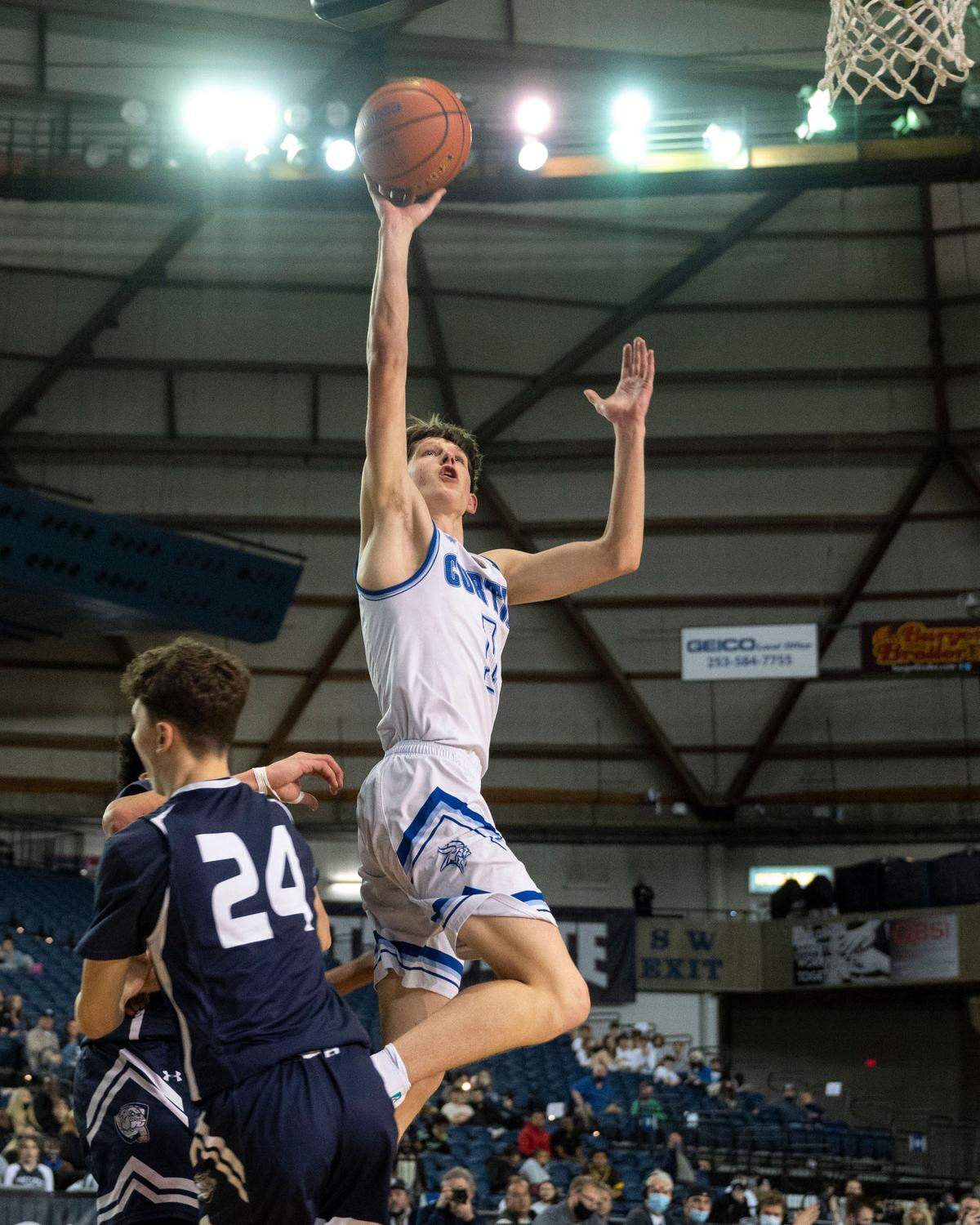 Curtis guard Tyce Paulsen (1) attempts a shot as Gonzaga Prep guard Carter Collins (24) attempts to take a charge during the fourth quarter of a Class 4A quarterfinal state tournament game on Thursday, March 3, 2022, at the Tacoma Dome, in Tacoma, Wash.
