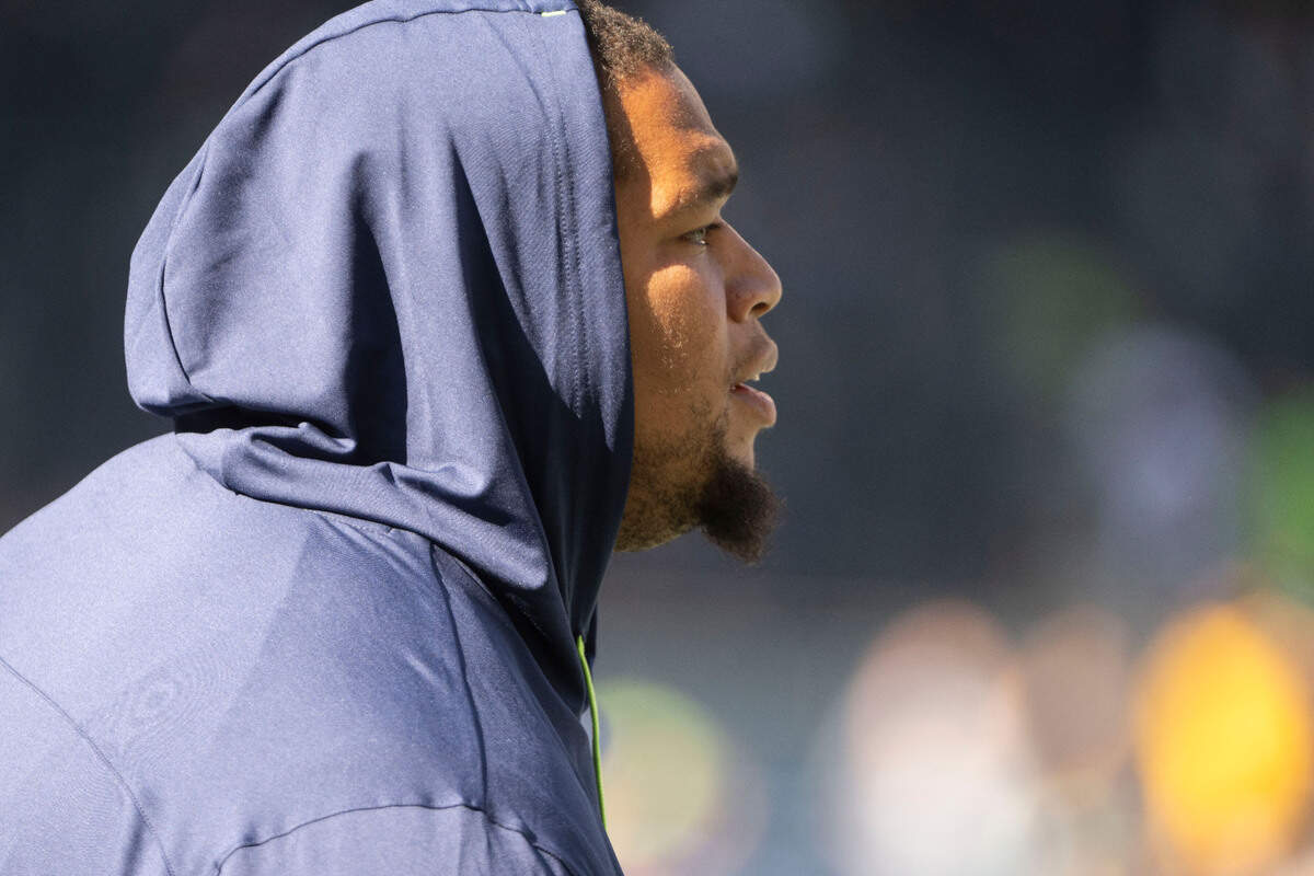 Seattle Seahawks defensive tackle Al Woods (99) looks on from the sideline in sweat pants as his teammates warm up prior to the start of an NFL game against the Arizona Cardinals on Sunday, Oct. 16, 2022, at Lumen Field in Seattle.