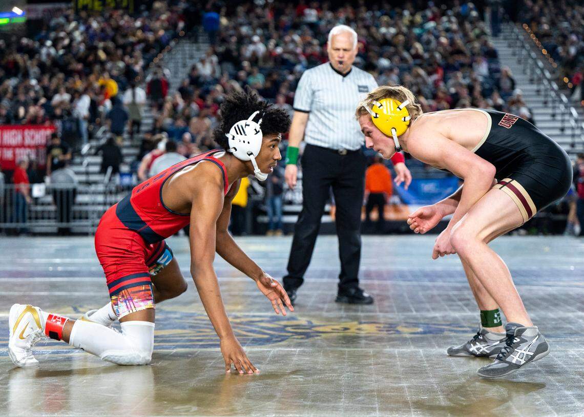 Silas Emanuel Cater looks University Taylor Daines in the eyes after missing a takedown during the 126-pound 3A quarterfinal match at Mat Classic XXXIV on Friday, Feb. 17, 2023, at the Tacoma Dome in Tacoma, Wash. Cater defeated Daines 4-1.