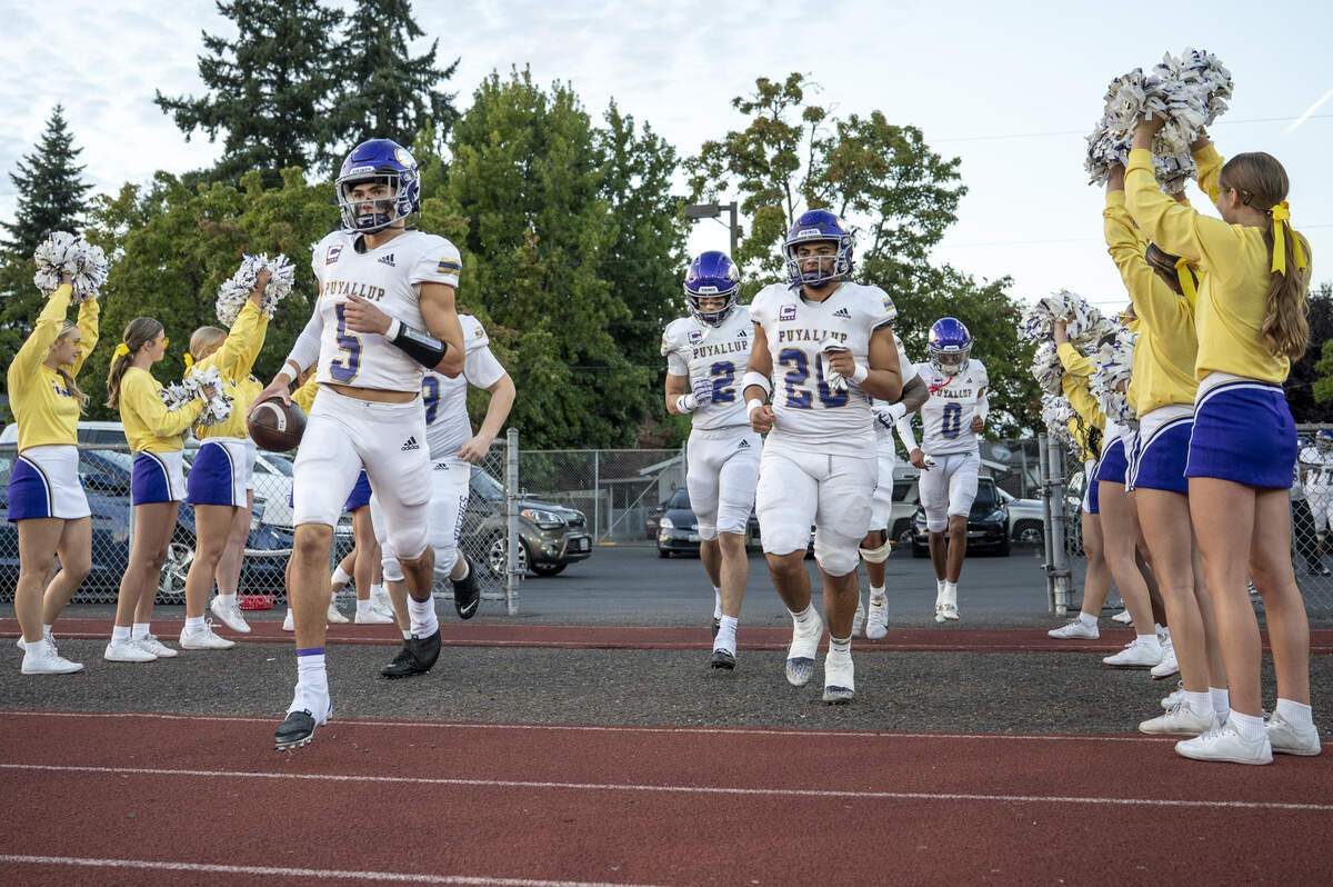 Puyallup players enter the stadium before a game against Emerald Ridge on Friday, Sept. 26, 2025, in Puyallup, Wash.