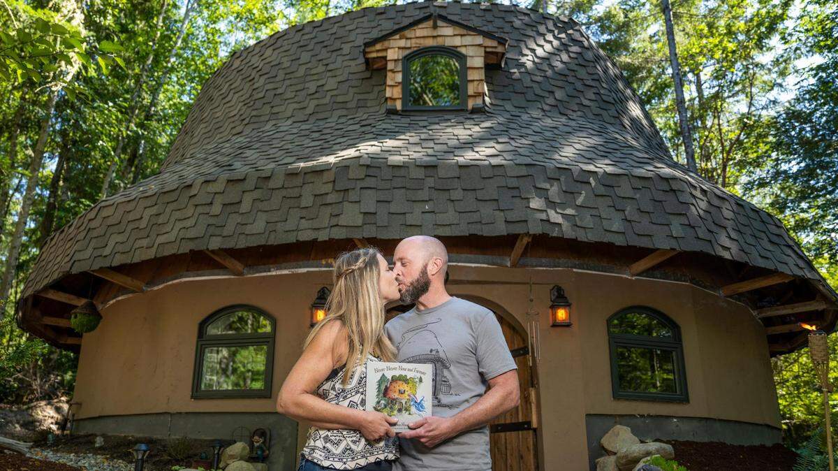 Rod Collen and Shannon Garrett in front of their mushroom house that they built on their property in Lakebay in August 2022. Collen has been missing since March 6 when he flew out of Tacoma Narrows Airport.
