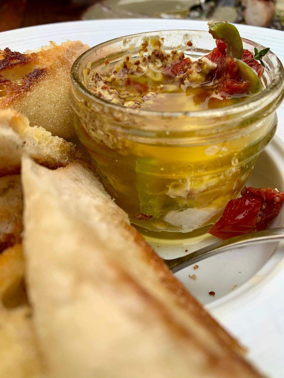 The chefs at Brix 25 in Gig Harbor, Wash., poach halibut, or other seasonal fish, in olive oil and serve it in a chutney jar with mustard seeds, tomatoes, olives and buttery grilled baguette.