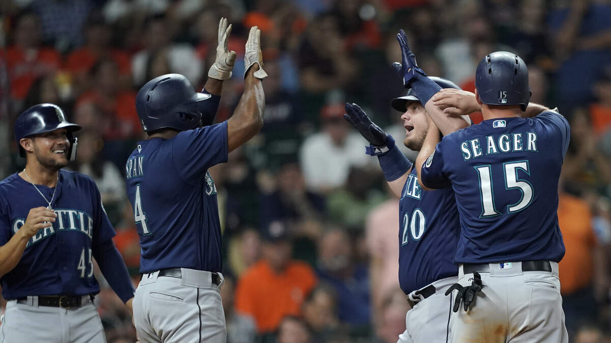 Seattle Mariners’ Daniel Vogelbach (20) celebrates with Kyle Seager (15), Denard Span (4) and Kristopher Negron (45) after they all scored on Vogelbach’s grand slam against the Houston Astros during the eighth inning of a baseball game Monday, Sept. 17, 2018, in Houston. (AP Photo/David J. Phillip)