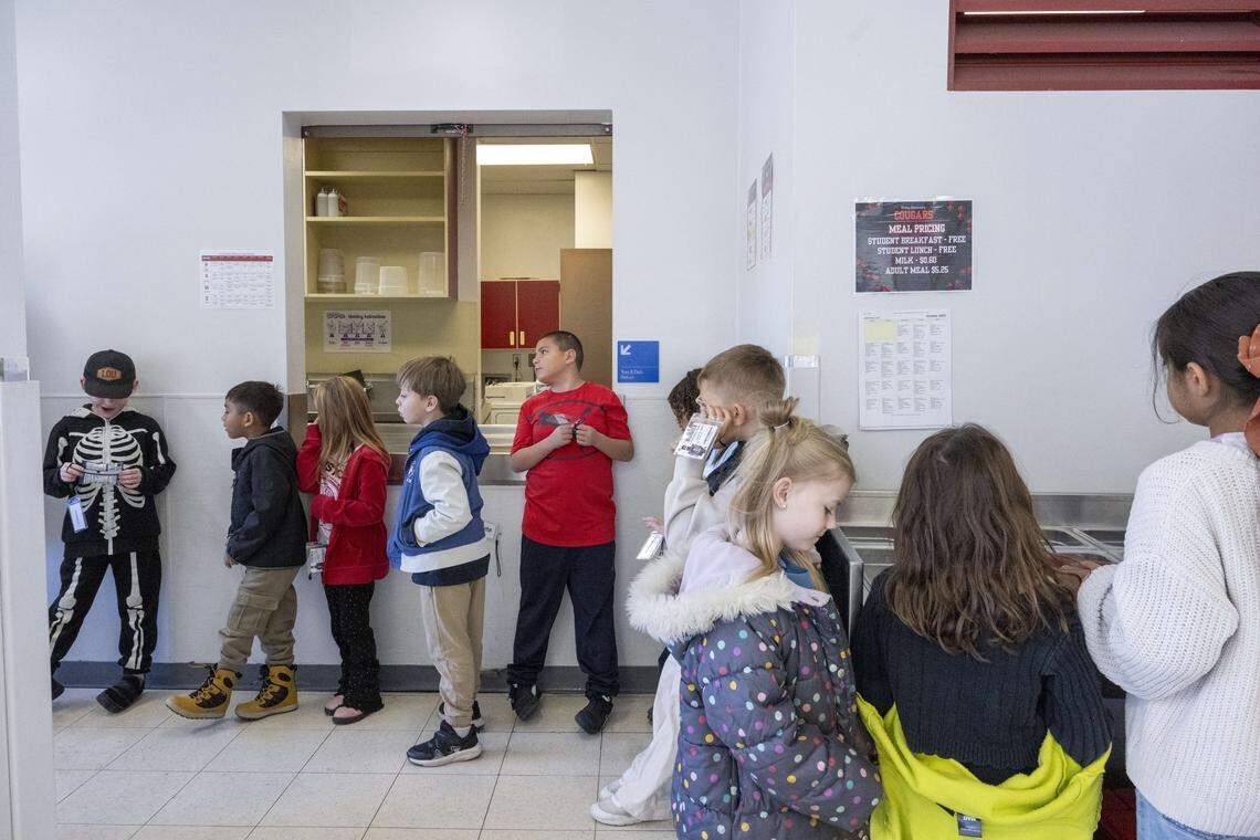 Orting Elementary School students wait in line for their lunches in the school's cafeteria on Wednesday, Oct. 15, 2025, in Orting, Wash.