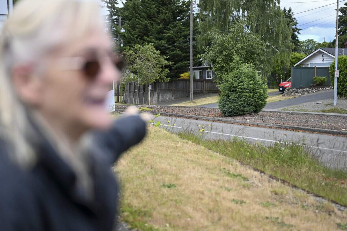 Deborah Willford, a North Tacoma resident of eight years, points out parts of North 21st Street that blocks the view of oncoming traffic for pedestrians and drivers on Wednesday, June 10, 2026, in Tacoma, Wash.