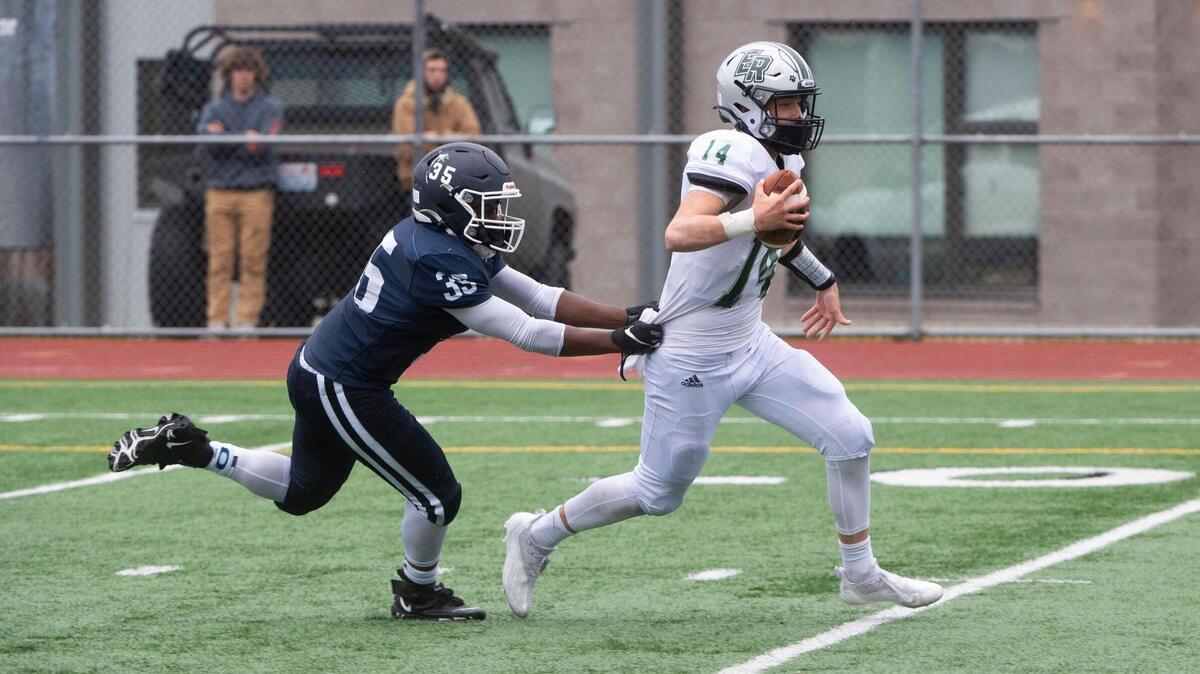 Emerald Ridge quarterback Jake Schakel scampers for yardage until Olympia linebacker Jaiden Woodfork brought him down. The Emerald Ridge Jaguars hung on to defeat the Olympia Bears, 28-26, at Ingersoll Stadium in Olympia on Saturday, Sept. 18, 2021.