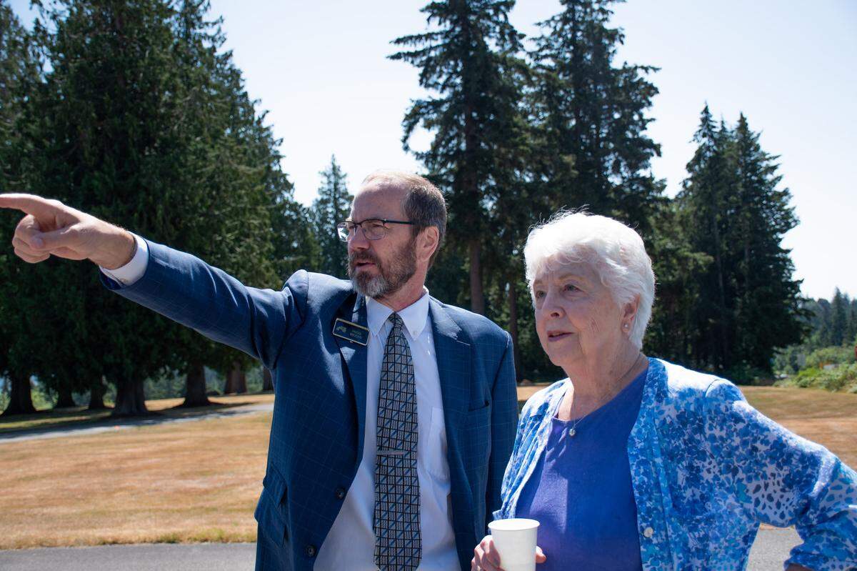 Russ Weeks, left, speaks with Barbara Rogers on July 12, 2024, at Haven of Rest, a local memorial park and funeral home off state Route 16 in the Gig Harbor area. Weeks co-owns the facility. Rogers has loved ones at the cemetery.
