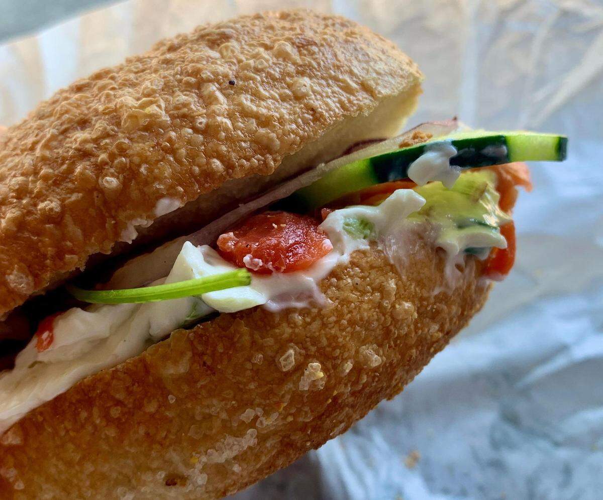 B’s Bagels & Butters bakes New York-style bagels in classic East Coast flavors, like this blistered salt holding scallion cream cheese, lox, capers, cucumbers and pickled onion.