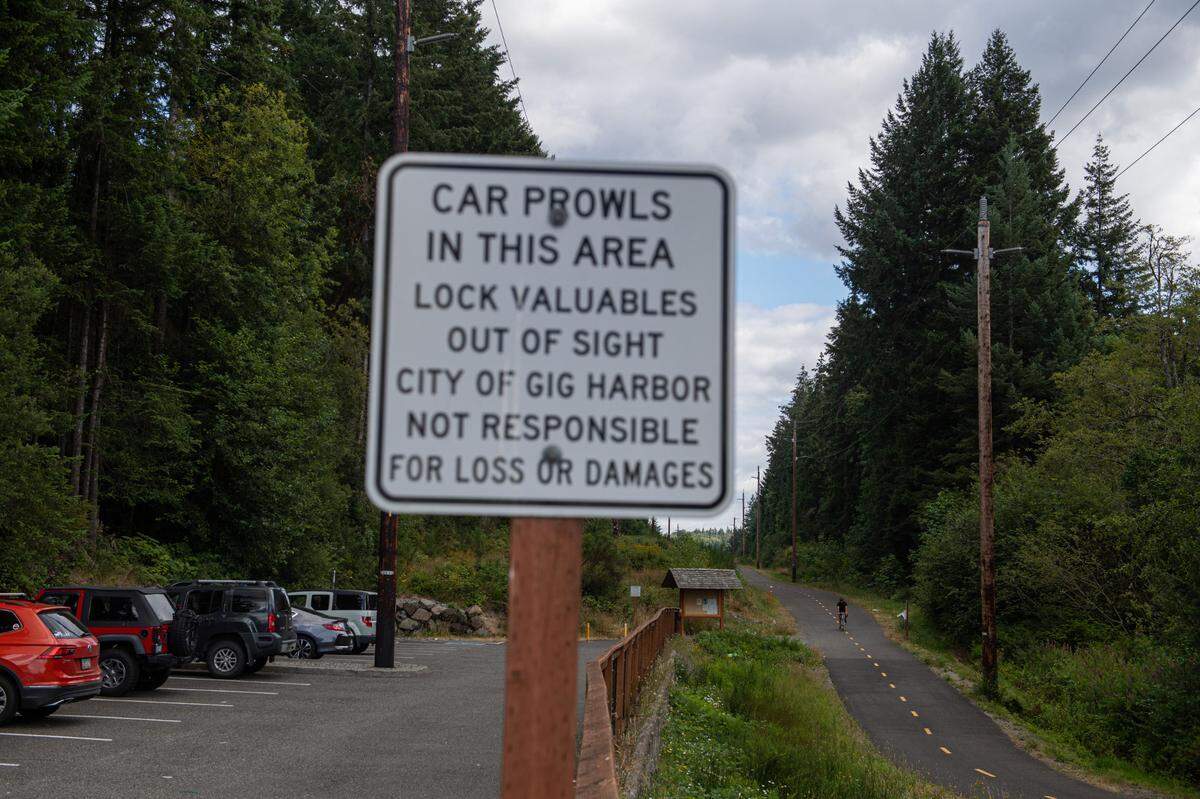 A sign warns people of potential car prowlers at the Cushman Trailhead in Gig Harbor, Wash., on Friday, July 17, 2020.
