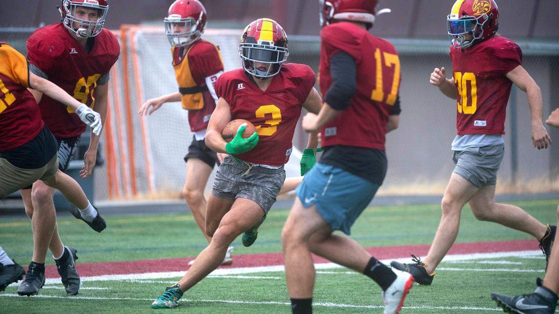 Enumclaw running back Dylan Waterson zig-zags through defenders during football practice at Enumclaw Stadium in Enumclaw, Washington, on Thursday, Aug. 25, 2021.