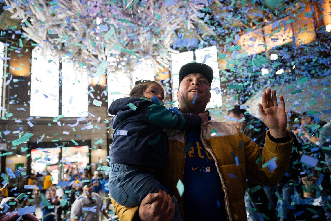 Confetti falls down as fans enter the park before the opening day game between the Boston Red Sox and Seattle Mariners at T-Mobile Park, on Thursday, March 28, 2024, in Seattle, Wash.