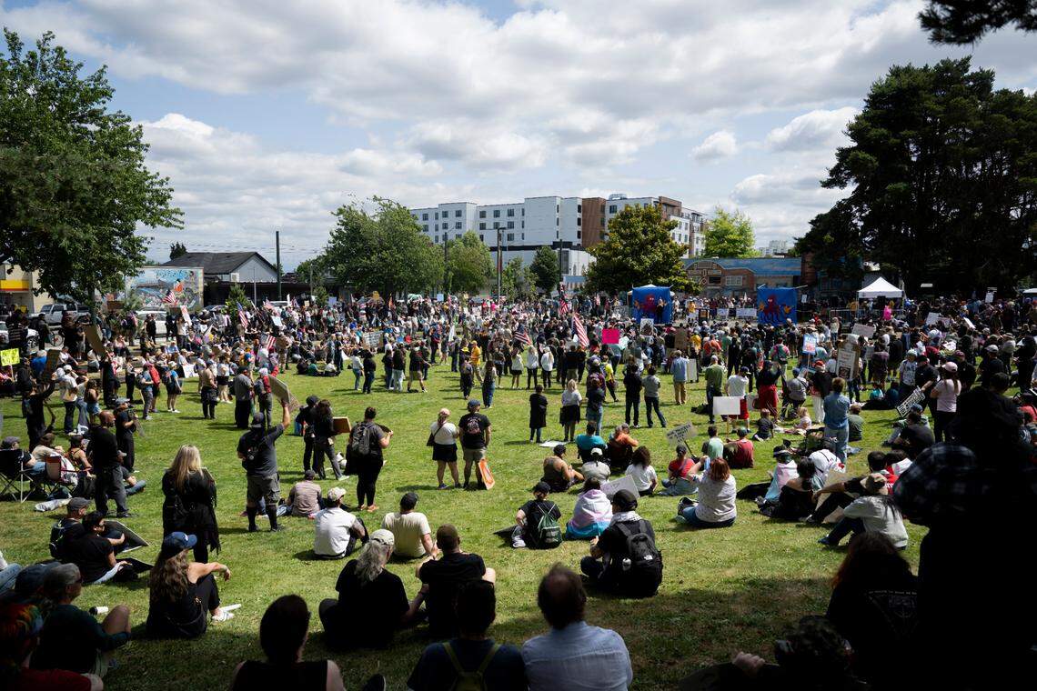 People gather and listen to speakers during a “No Kings” protest at People’s Park on Saturday, June 14, 2025, in Tacoma, Wash.