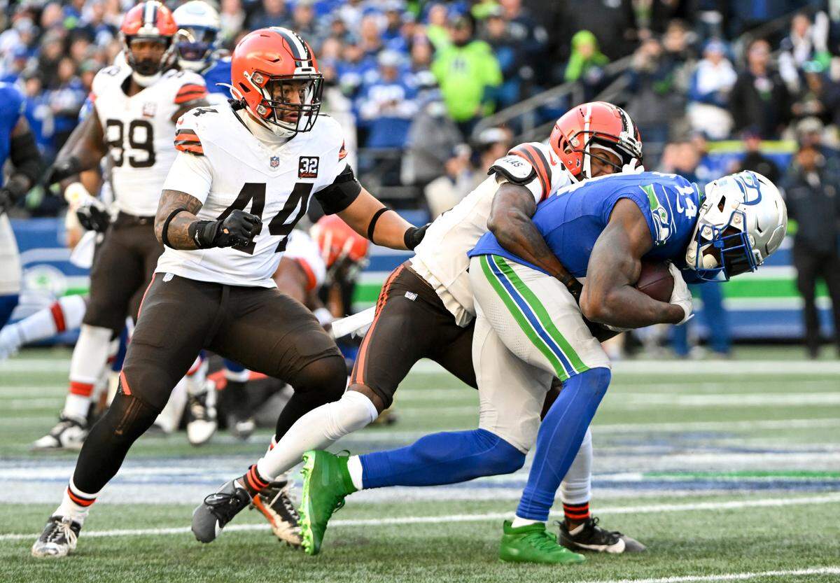 Seattle Seahawks wide receiver DK Metcalf (14) hangs on for extra yards after the tackle form Cleveland Browns cornerback Denzel Ward (21) during the fourth quarter of the game at Lumen Field, Sunday, Oct. 29, 2023, in Seattle, Wash.