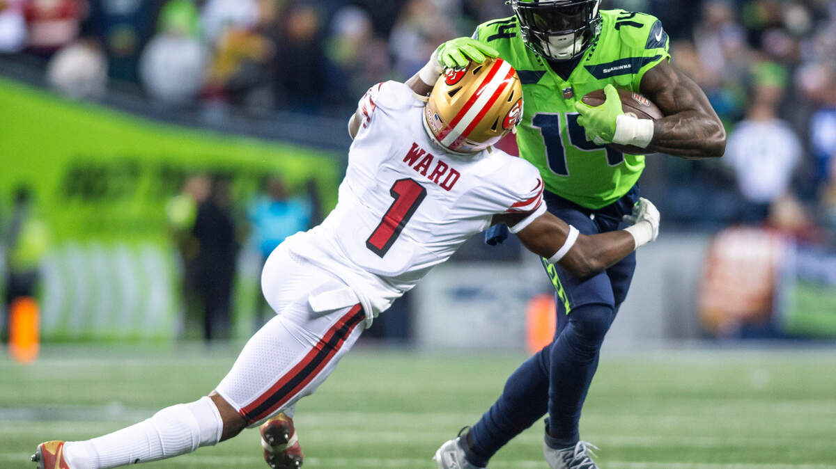 Seattle Seahawks wide receiver DK Metcalf (14) is tackled by San Francisco 49ers cornerback Jimmie Ward (1) in the third quarter of an NFL game at Lumen Field in Seattle Wash. on Dec. 15, 2022.