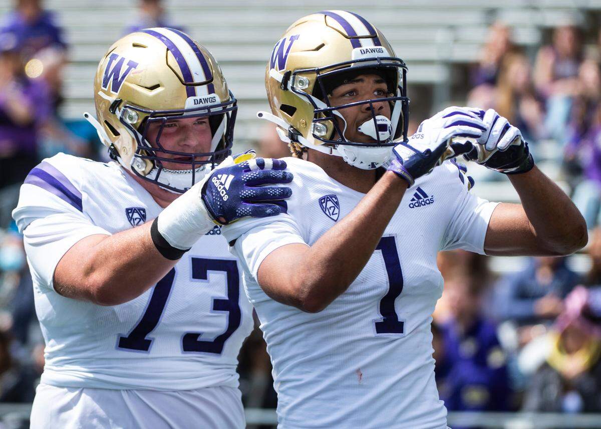 University of Washington Huskies wide reciever Rome Odunze (1) makes a heart with his hands for the fans as he celebrates making a touchdown during the spring game at Husky Stadium in Seattle, Wash. on Saturday, April 30, 2022.