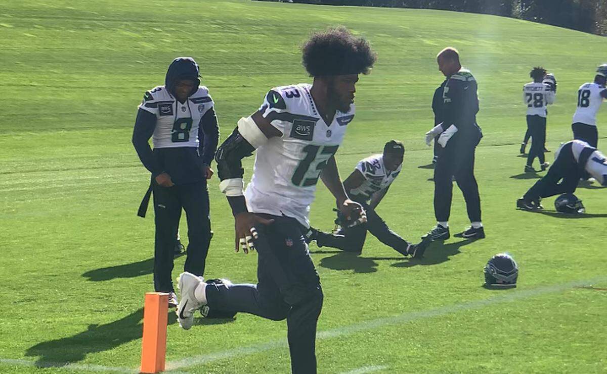 New middle linebacker Ernest Jones IV (13) jogs past safety Coby Bryant (8) and his new Seahawks teammates to begin his first practice with Seattle Oct. 24, 2024. The day before the Seahawks traded with the Tennessee Titans to acquire Jones, a Super Bowl winner with the Los Angeles Rams in February 2022.