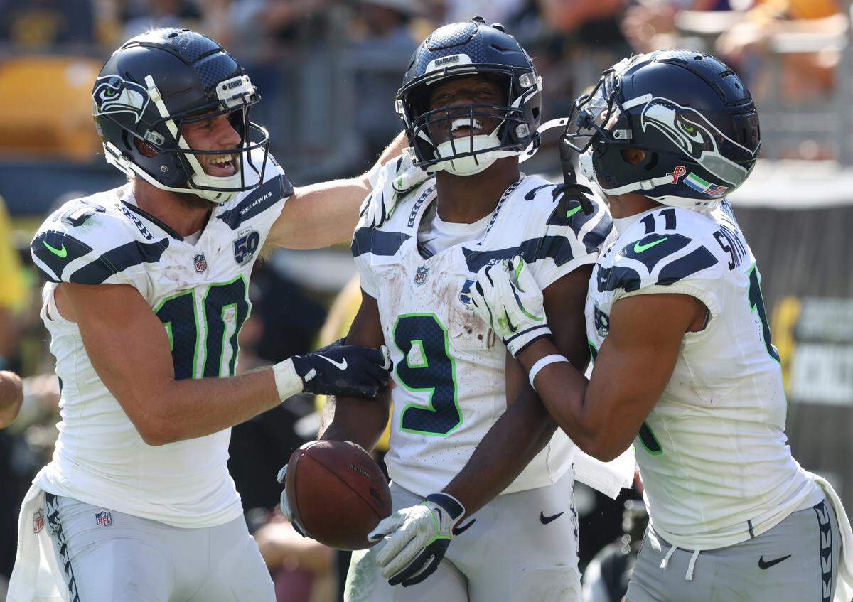 Sep 14, 2025; Pittsburgh, Pennsylvania, USA; Seattle Seahawks wide receivers Cooper Kupp (10) and Jaxon Smith-Njigba (11) congratulate running back Kenneth Walker III (9) on his touchdown against the Pittsburgh Steelers during the fourth quarter at Acrisure Stadium. Mandatory Credit: Charles LeClaire-Imagn Images