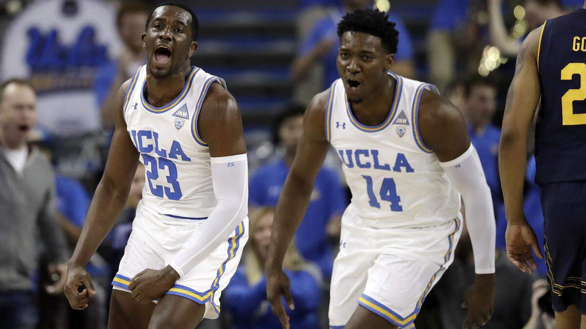 UCLA guard Prince Ali (23) celebrates after dunking in front of teammate Kenneth Nwuba (14) during the first half of an NCAA college basketball game against California Saturday, Jan. 5, 2019, in Los Angeles. (AP Photo/Marcio Jose Sanchez)