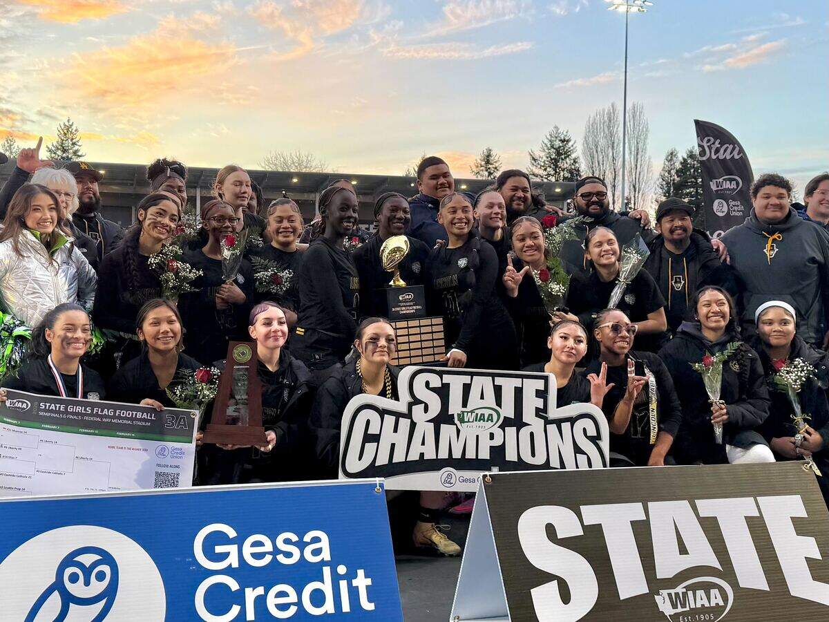 No. 1 Lincoln’s girls flag football team poses for a portrait with the championship trophy after beating No. 10 Seattle Prep, 21-14, in the 3A state title game at Federal Way Memorial Field on Feb. 14, 2026, in Federal Way, Wash.