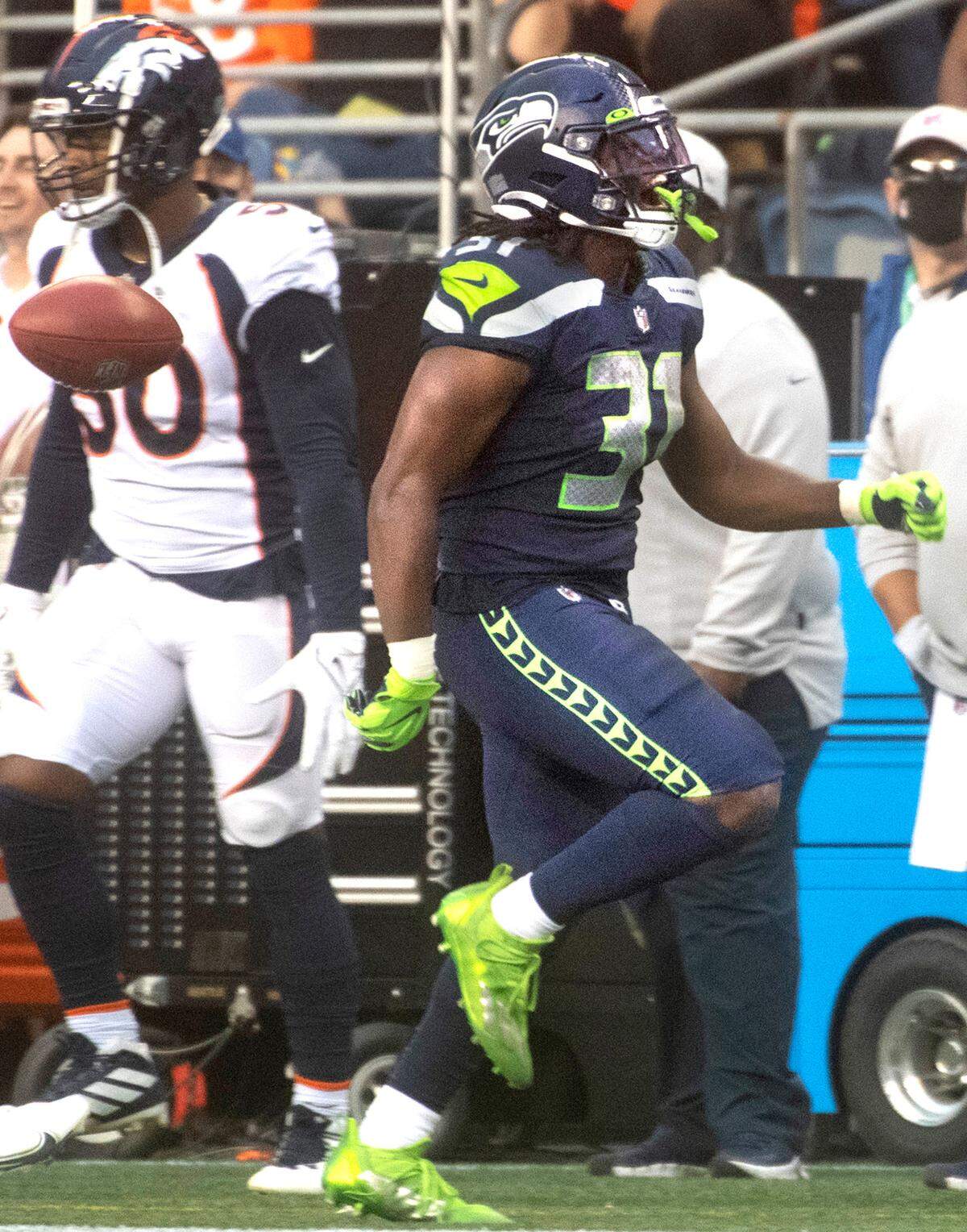 Seahawks running back DeeJay Dallas lets out a whoop after a long kickoff return during Saturday night’s NFL preseason football game against the Denver Broncos at Lumen Field in Seattle, Washington, on Saturday, Aug. 21, 2021.