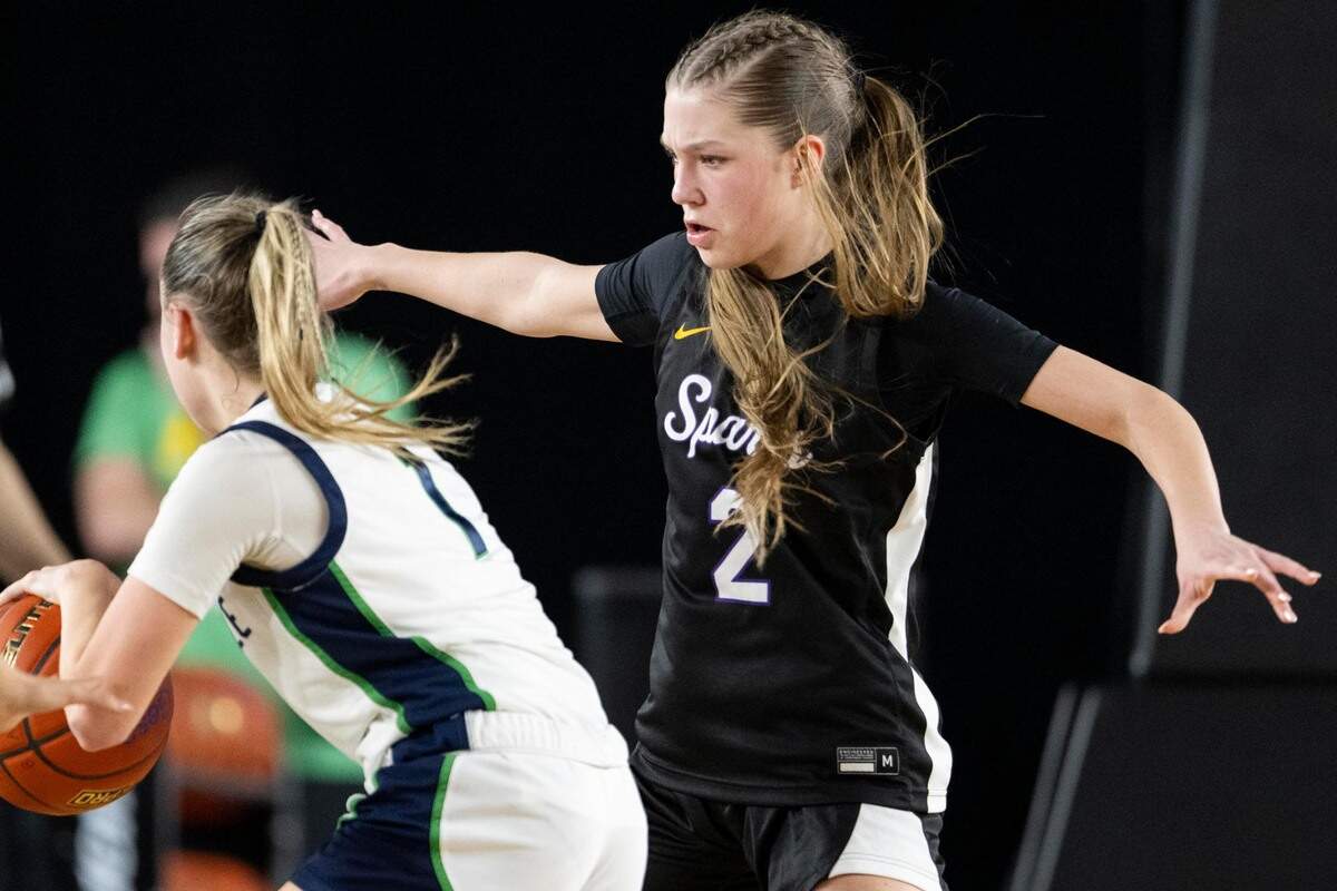 Sumner guard Mae Cocke (2) plays defense on Woodinville guard Sienna Bieler (1) during the fourth quarter of a Class 4A state basketball tournament semifinal game at the Tacoma Dome on Friday, March 7, 2025, in Tacoma, Wash.