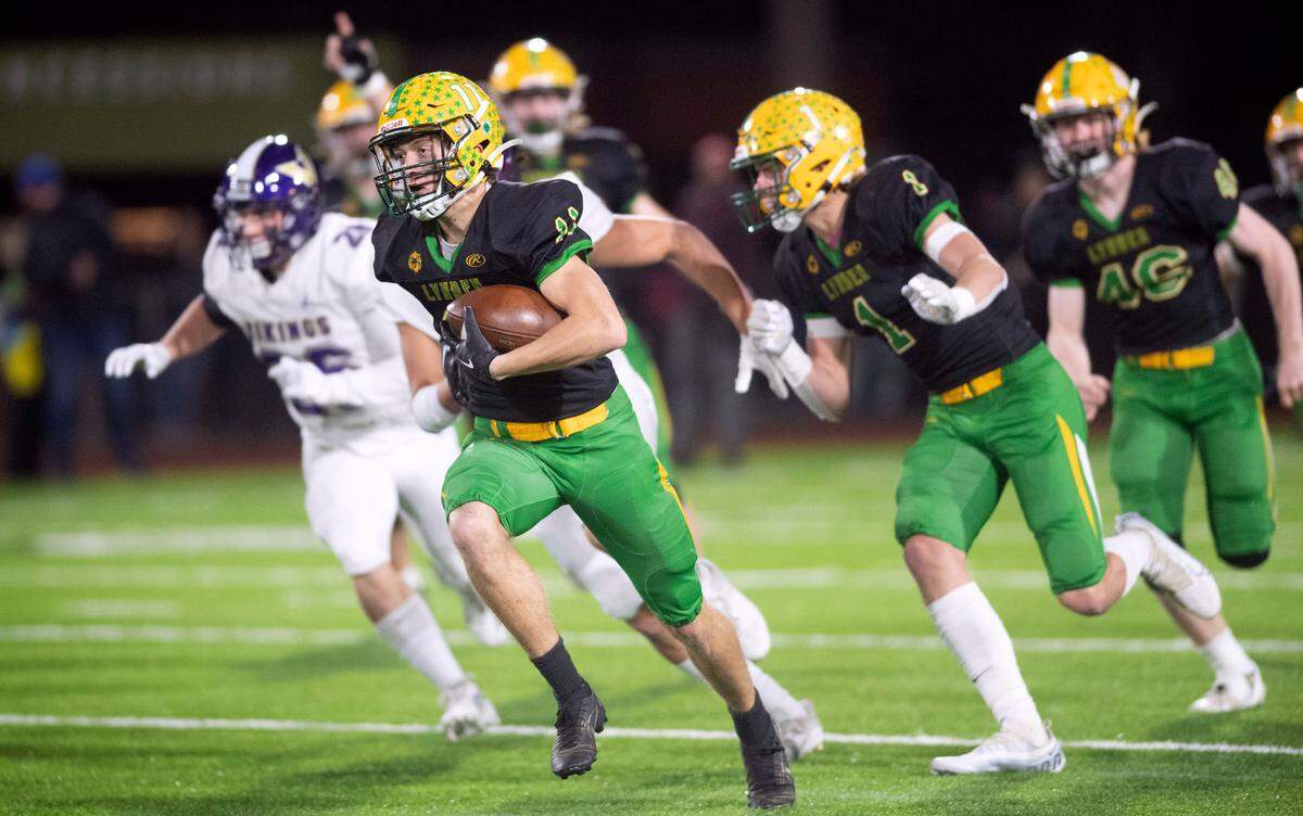 Lynden defensive back Troy Petz races to the end zone after scooping up a blocked North Kitsap field goal attempt during the 2A football state championship game at Sparks Stadium in Puyallup, Washington, on Saturday, Dec. 3, 2022.