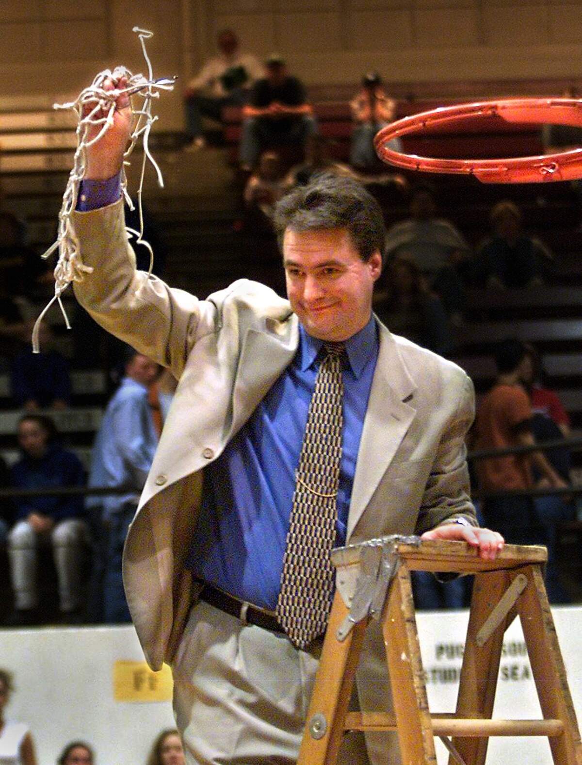 SLUG: TIM KELLY/ABES COACH RUN DATE: SPORTS, 3/6/02 PHOTO TAKEN: Tacoma, Saturday, March 2, 2002 Abes coach Tim Kelly beams after cutting the final strands of the net at the request of his players following Lincoln’s win over Bethel in the district title game. (Drew Perine/The News Tribune)