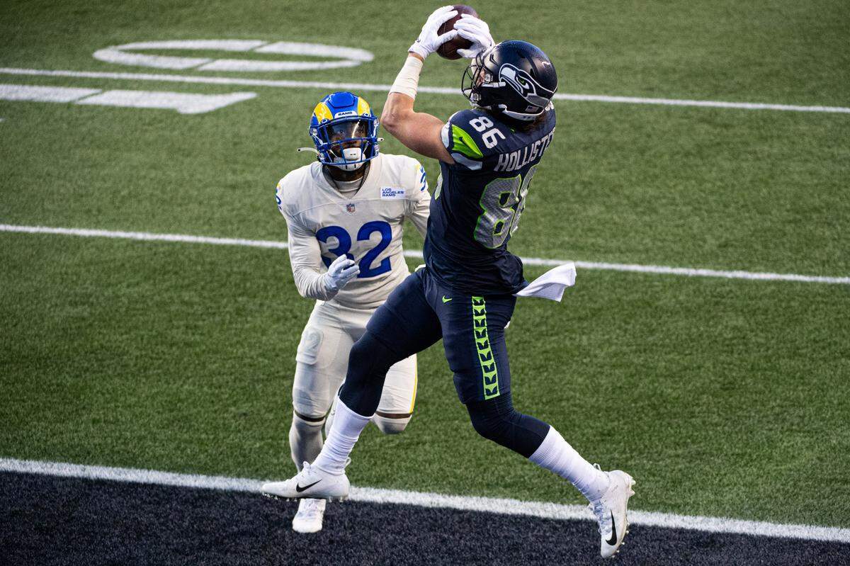 Seattle Seahawks tight end Jacob Hollister catches a touchdown pass over Los Angeles Rams cornerback Troy Hill during the fourth quarter. The Seattle Seahawks played the Los Angeles Rams in a NFL football game at Lumen Field in Seattle, Wash., on Sunday, Dec. 27, 2020.