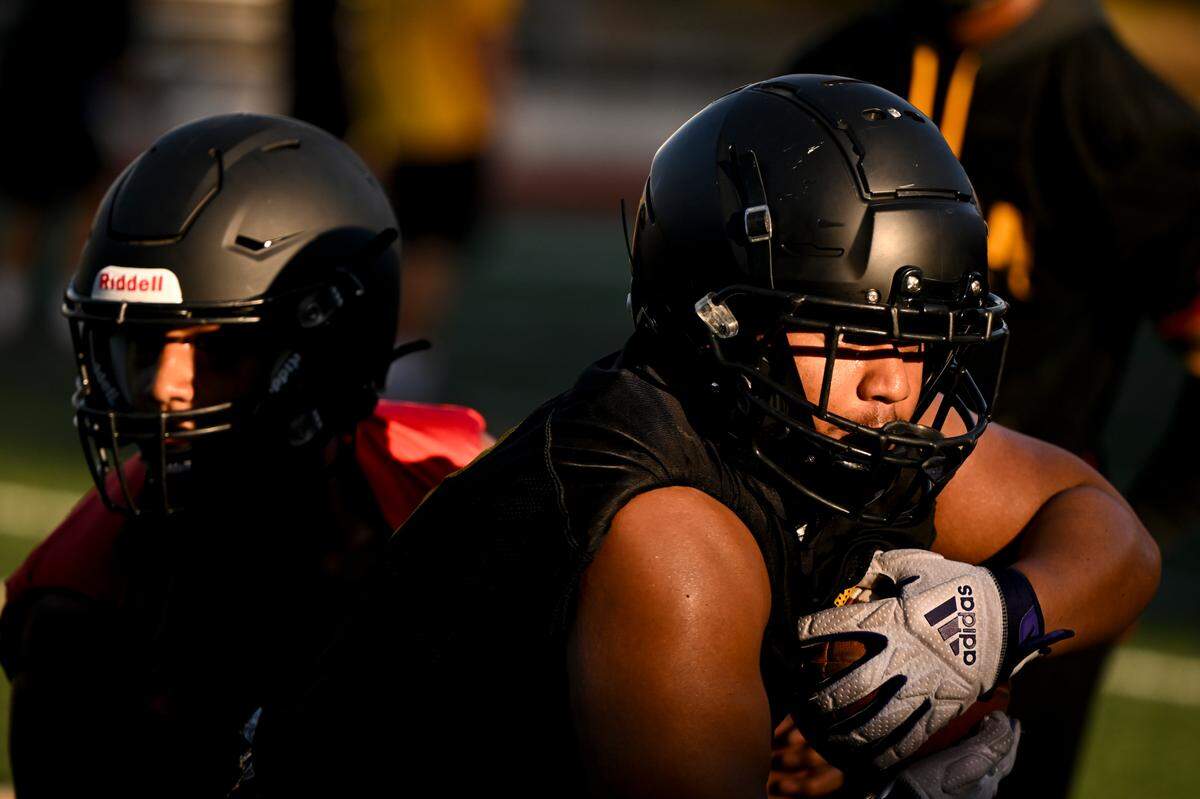 Lincoln running back Kelly Sio-Fetaui runs a play during practice at Lincoln High School, Friday, Aug. 18, 2023, in Tacoma, Wash.