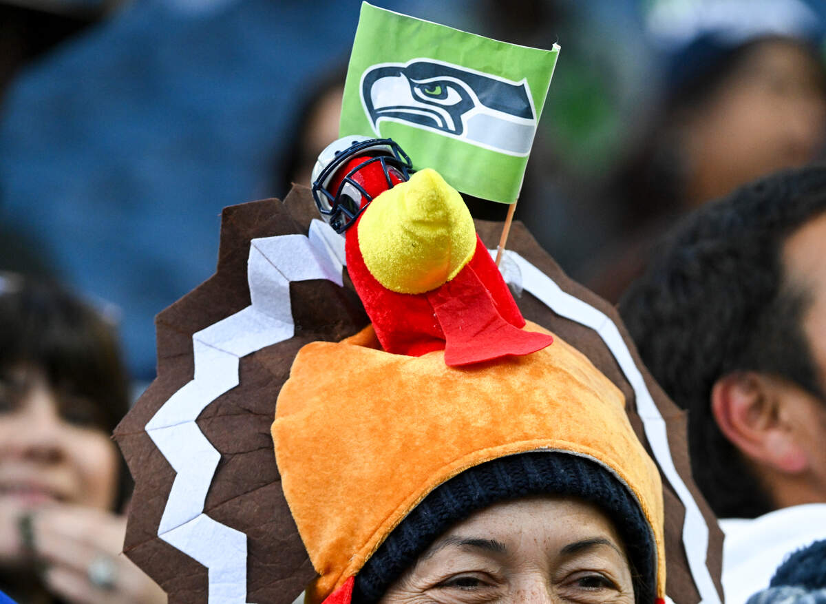 Fans cheer and hold signs before the game between the Seattle Seahawks and the San Francisco 49ers at Lumen Field, Thursday, Nov. 23, 2023, in Seattle, Wash.