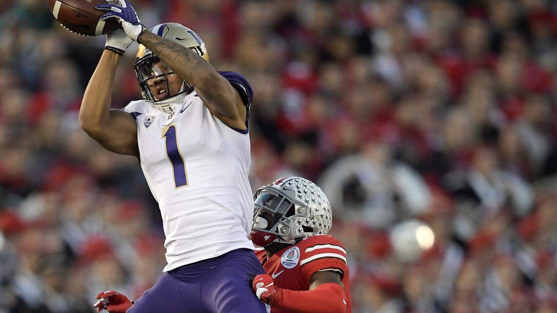 Washington tight end Hunter Bryant catches a pass over Ohio State safety Jordan Fuller during the second half of the Rose Bowl NCAA college football game Tuesday, Jan. 1, 2019, in Pasadena, Calif. (AP Photo/Mark J. Terrill)