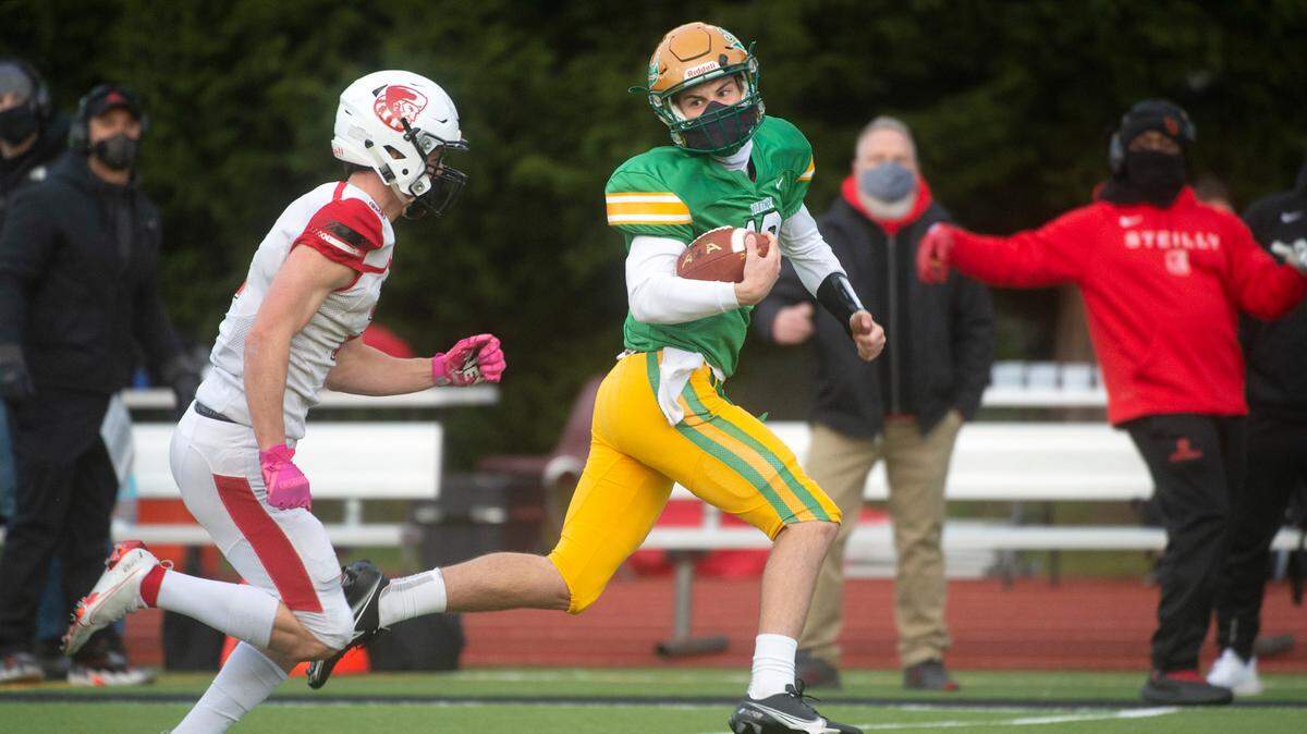 Tumwater quarterback Cody Whalen tries to break away from Steilacoom defensive back Logan Brady during Saturday night’s high school football game at Tumwater District Stadium on Saturday, March 20, 2021.