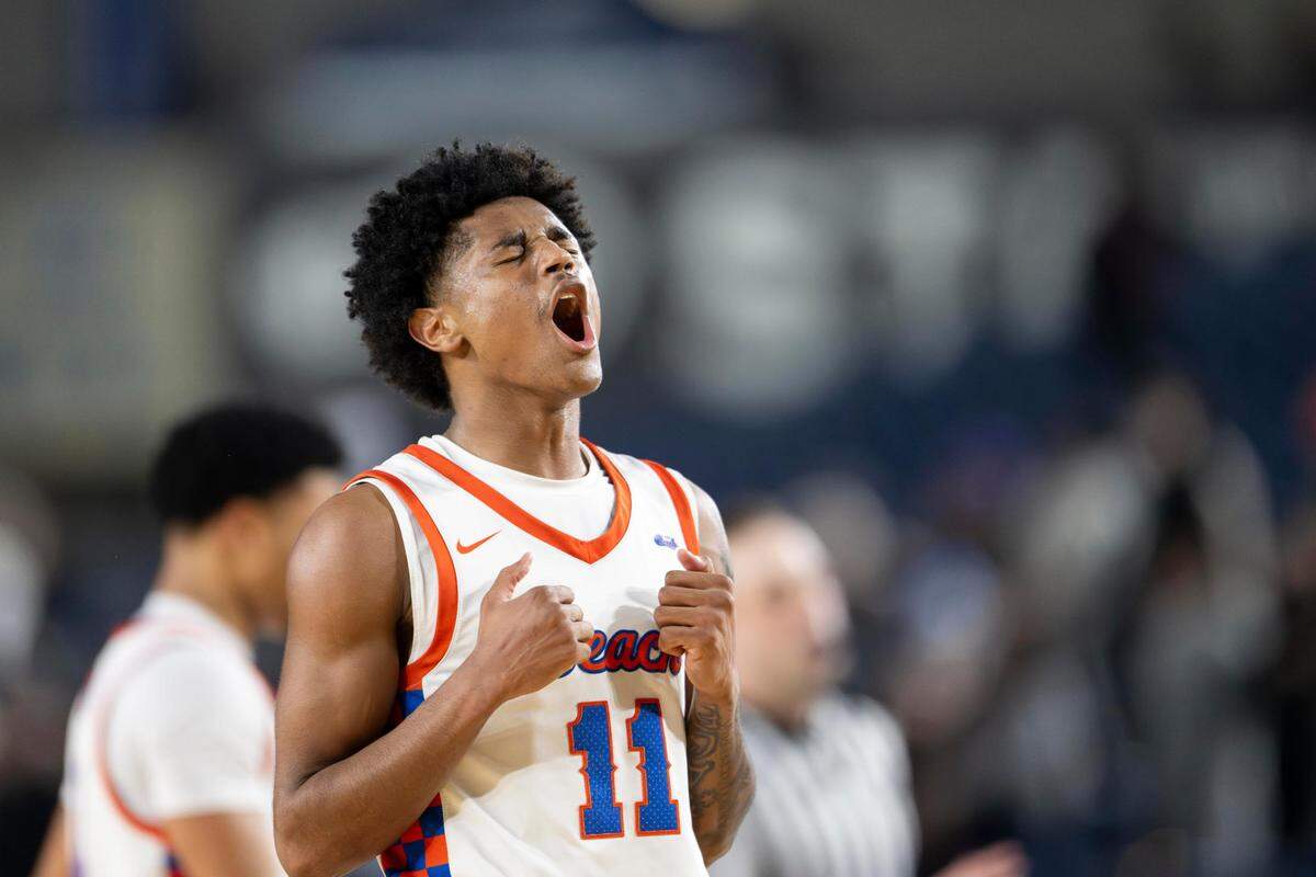 Rainier Beach guard Jaylen Petty (11) celebrates after a Garfield foul late in the fourth quarter of a Class 3A state basketball tournament semifinal game at the Tacoma Dome on Friday, March 7, 2025, in Tacoma, Wash.
