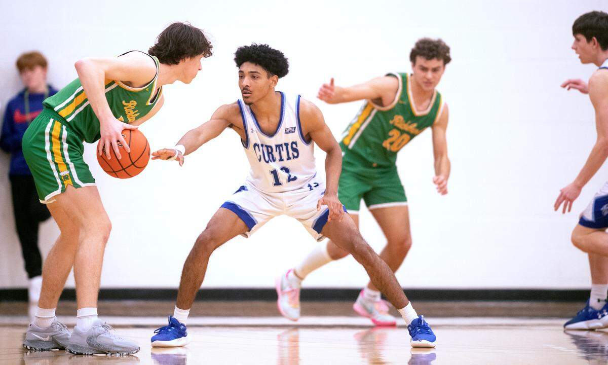 Curtis defender Cinque Maxwell squares off against Richland’s Jack Forbes during Friday night’s 4A boys state regional playoff game at Tacoma Community College in Tacoma, Washington, on Feb. 24, 2023. Curtis won the game, 64-55.