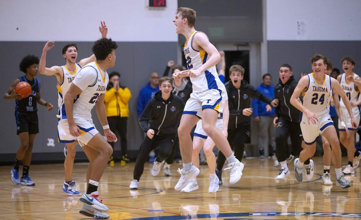 Tahoma’s Adam Davis and his Bears teammates celebrate after Davis scored the game-winning basket with .7 seconds to play in Thursday night’s 4A District 3/4 boys semifinal basketball game at Federal Way High School in Federal Way, Washington, on Feb. 15, 2023. Tahoma won the game, 67-66.