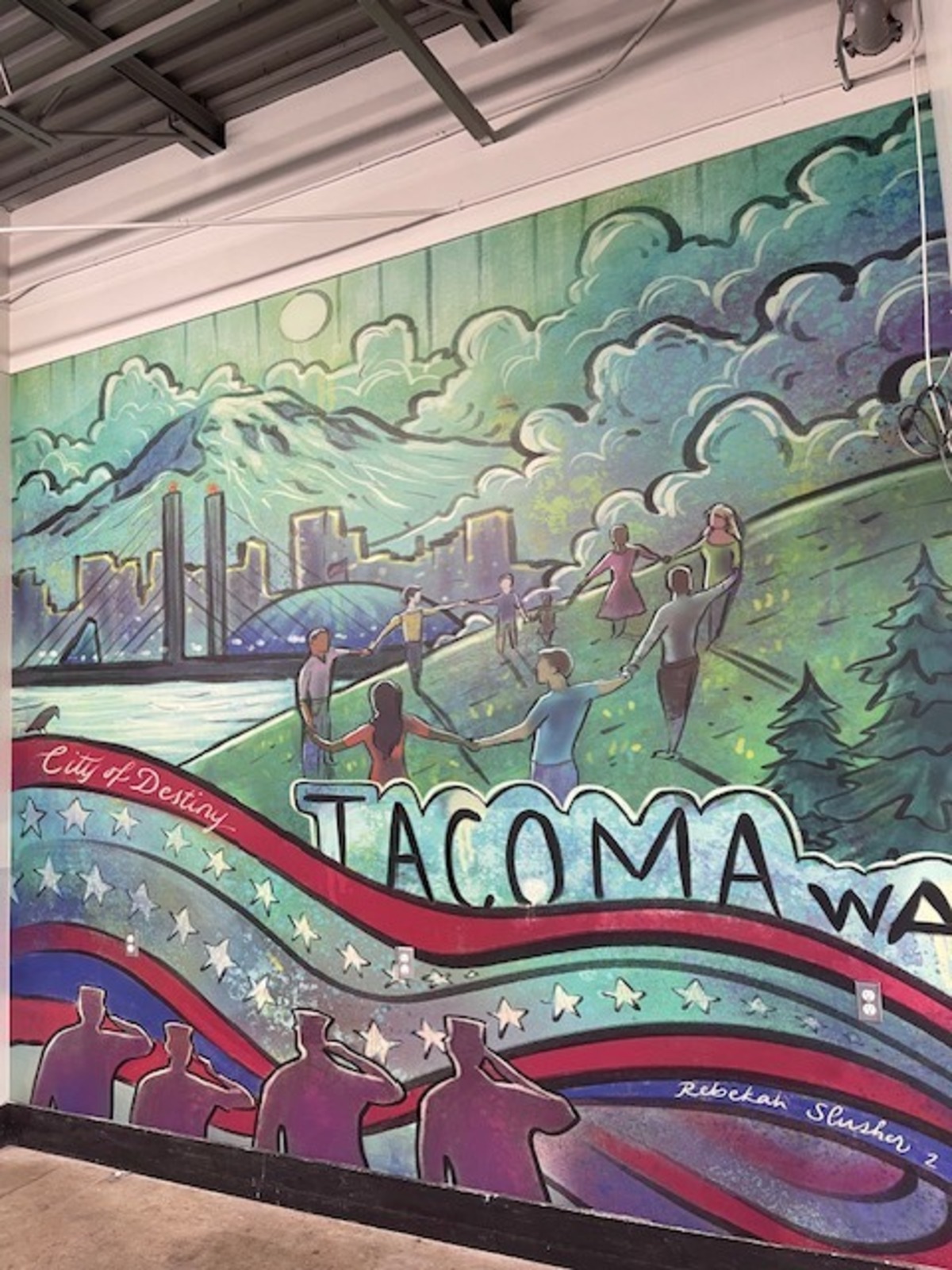 A new Tacoma-themed mural greets shoppers at the newly remodeled Walmart Supercenter, 1965 S. Union Ave..