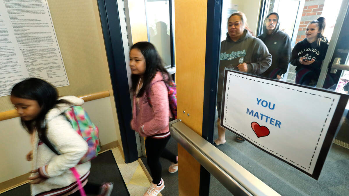Students and parents arrive at Blix Elementary School on the first day of classes Monday following the resolution of a strike last week by Tacoma Public Schools teachers.
