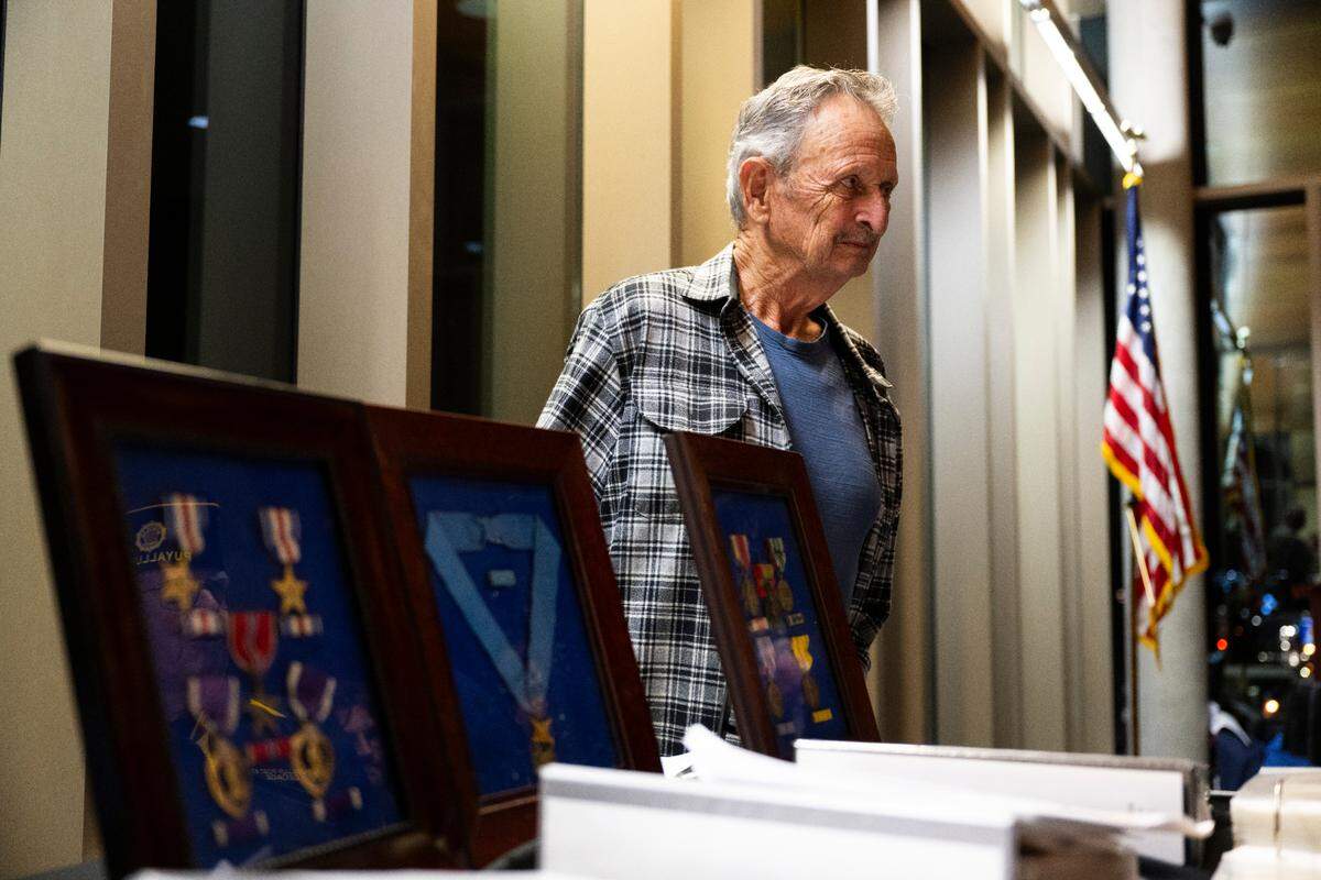 Terry Kandle, son of World War II soldier Lt. Victor Kandle talks with guests during a dedication ceremony to rename the lobby in honor of his father at Puyallup City Hall, on Tuesday, Nov. 12, 2024 in Puyallup.