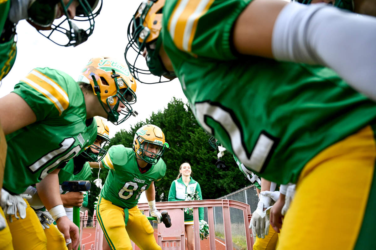 Tumwater Thunderbirds huddle before running on the field before the first half of the 2A state quarterfinals against the Clarkston Bantams at Tumwater District Stadium, Saturday, Nov. 18, 2023, in Tumwater, Wash.