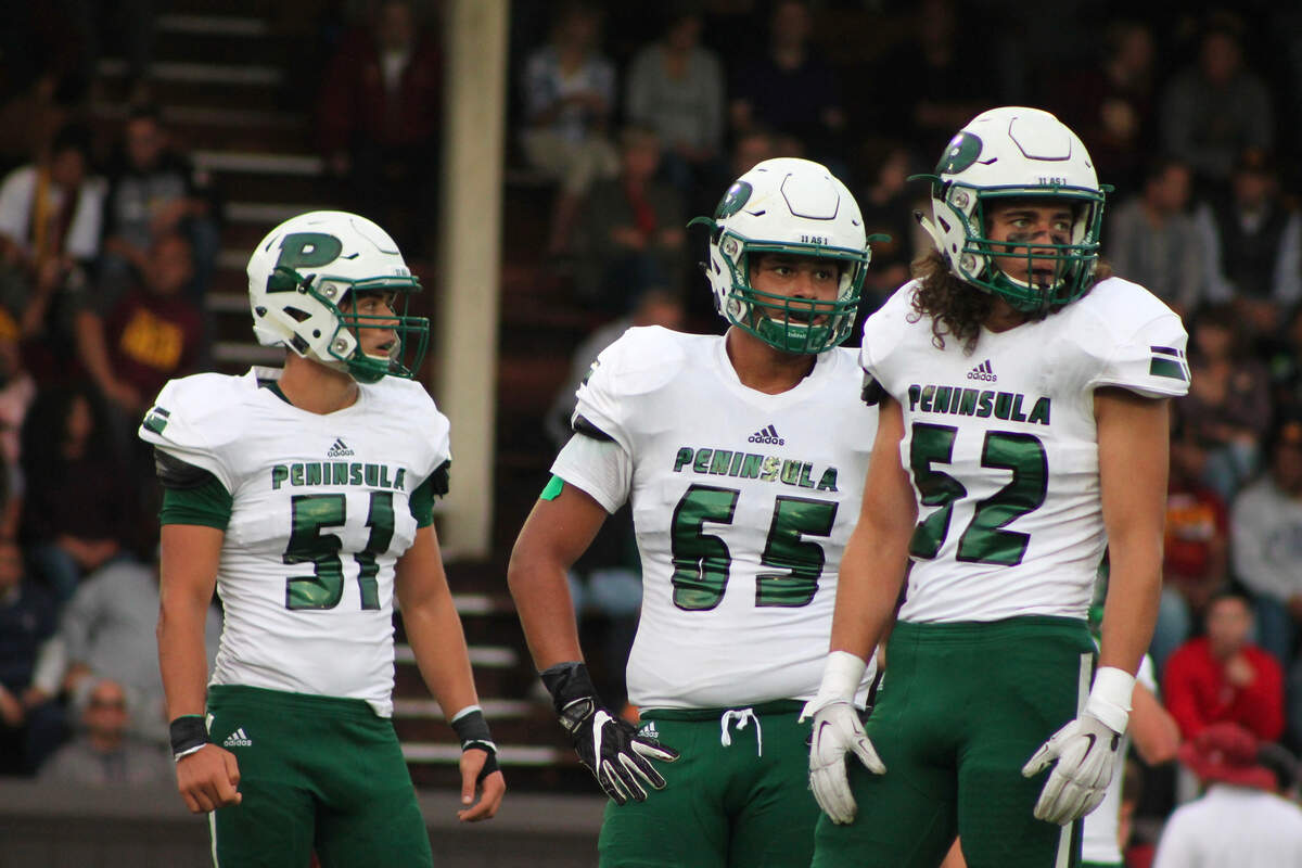 Peninsula’s Graham Schmidt, Khalif Spry and Isaiah Juvik against O’Dea at West Seattle Stadium on Friday, Aug. 31. O’Dea won the season opener, 28-0.