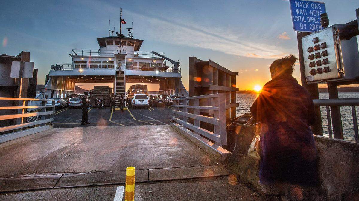 Walk on passengers and drivers board the Anderson Island ferry on their way to the mainland on Thursday, March 17 2016.