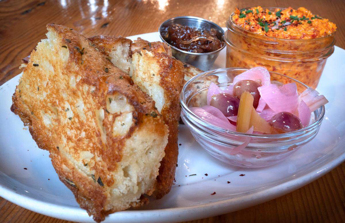 The beloved pimento cheese with spicy pickles, onion jam and grilled focaccia — all made in house — is one of several menu items that will remain.