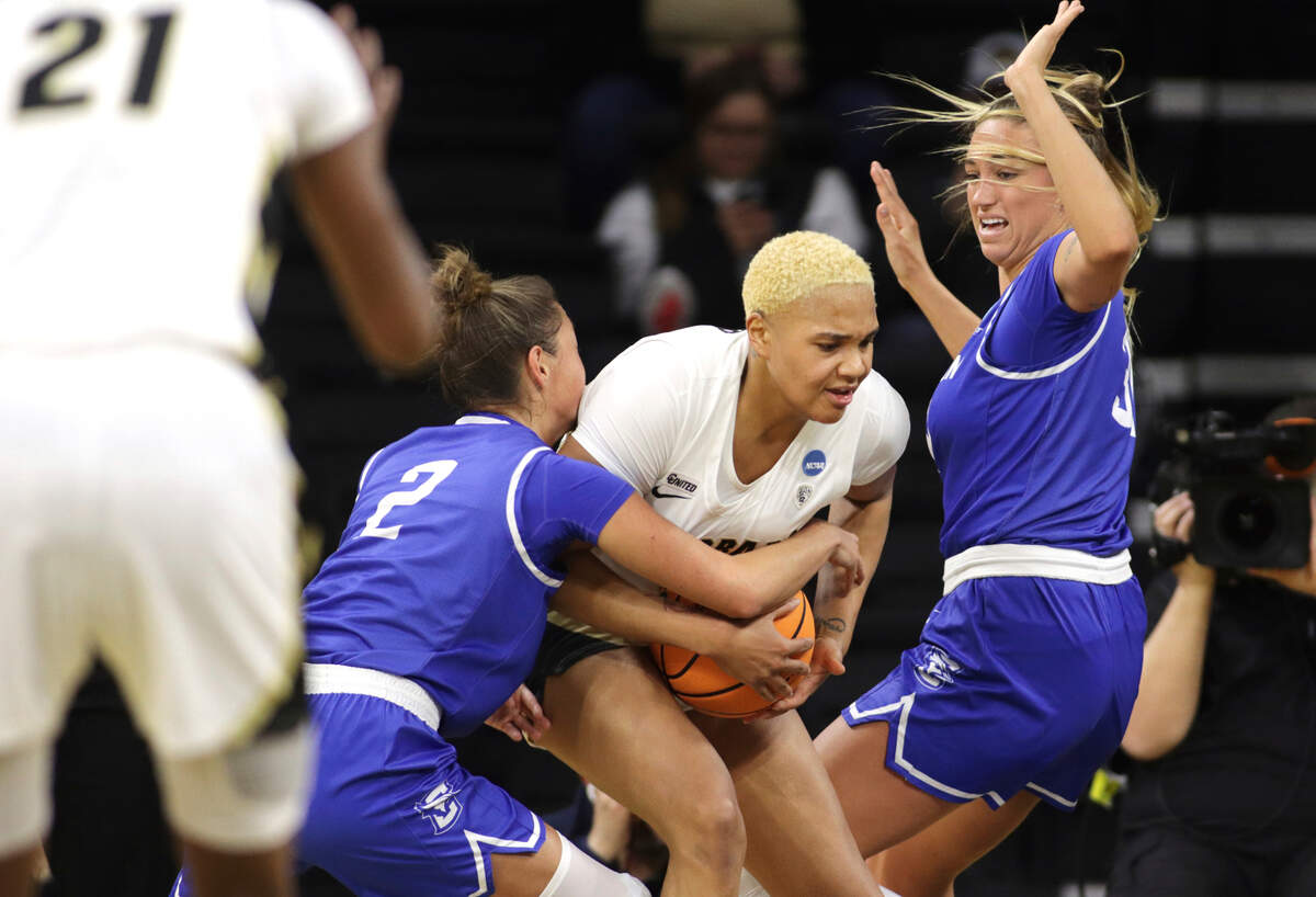 Creighton guard Tatum Rembao (2) and teammate forward Emma Ronsiek (31) team up on Colorado center Quay Miller (11) during the second half of a first-round game in the NCAA women’s college basketball tournament, Friday, March 18, 2022, in Iowa City, Iowa. (AP Photo/Ron Johnson)