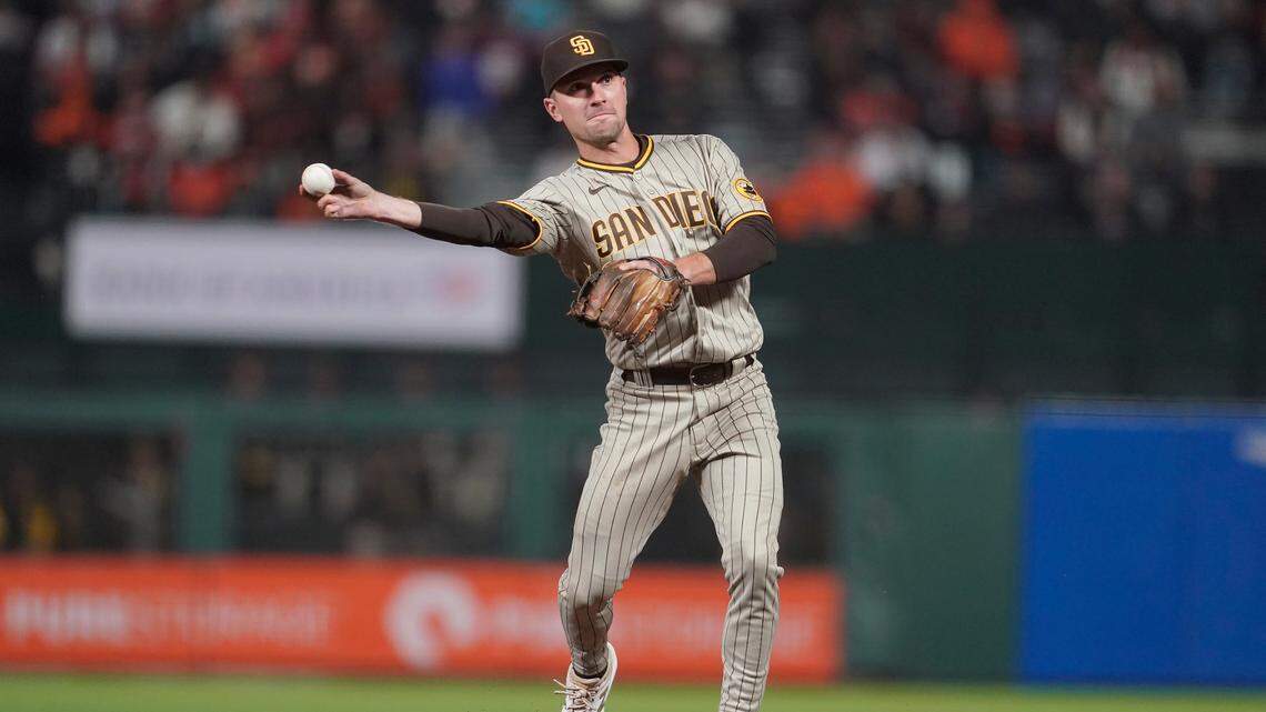 San Diego Padres second baseman Adam Frazier throws out San Francisco Giants’ Brandon Belt at first base during the third inning of a baseball game in San Francisco, Wednesday, Sept. 15, 2021. (AP Photo/Jeff Chiu)