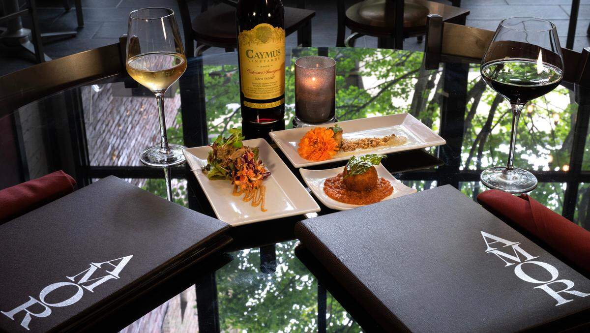 The 2023 opening tapas menu at Amor included dishes such as duck confit on a chive crepe, scallops with vinegar maple glaze and arancini.