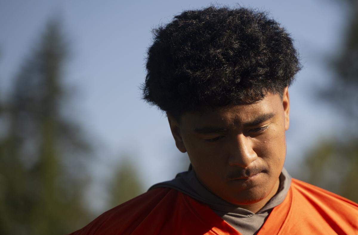 Graham-Kapowsin quarterback AJ Tuivaiave warms up during a football practice at Graham-Kapowsin High School on Friday, Aug. 22, 2025, in Graham, Wash.
