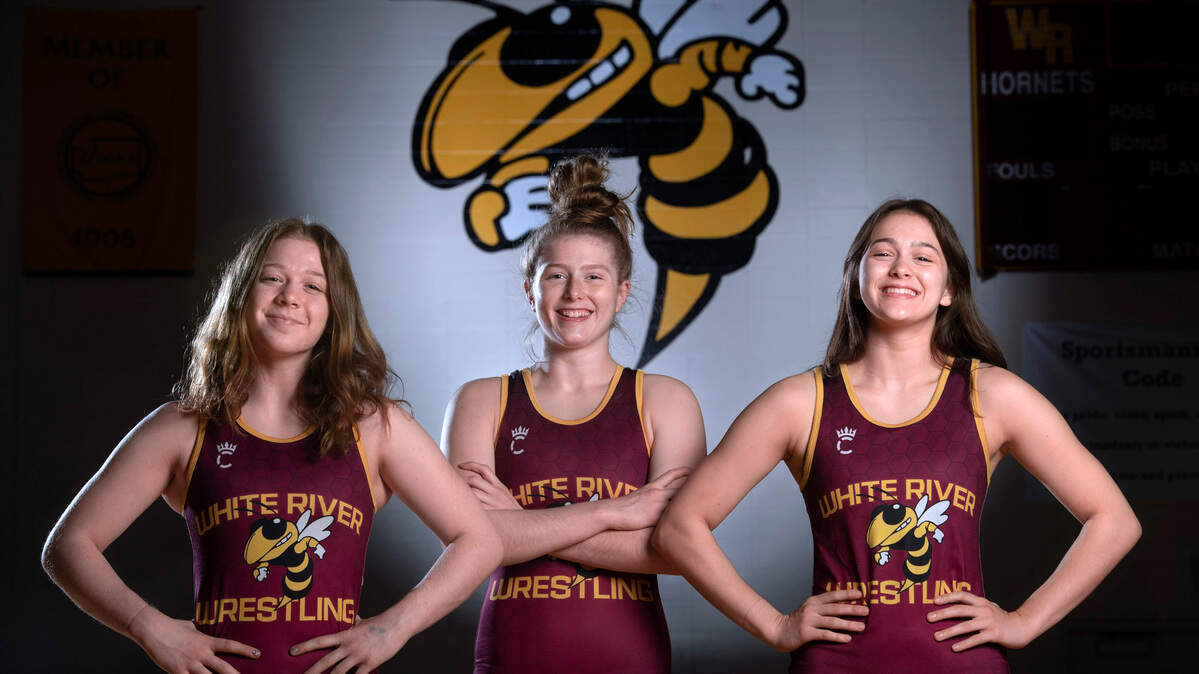 White River sophomore Shelby Moore (from left), senior state champion Claire DiCugno and sophomore Anna DiCugno won’t get to return to the Mat Classic this season because of COVID-19 restrictions. In addition to Claire DiCugno’s title at 125 pounds, the sophomores both finished third last year. The trio are shown before wrestling practice at White River High School in Buckley, Washington, on Tuesday, May 25, 2021.