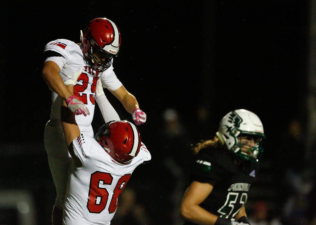 Yelm’s Bradley McGannon and Carson Amendt celebrate a rushing touchdown in the third quarter. Peninsula played Yelm in a football game at Roy Anderson Field in Purdy, Wash., on Friday, Oct. 18, 2019.