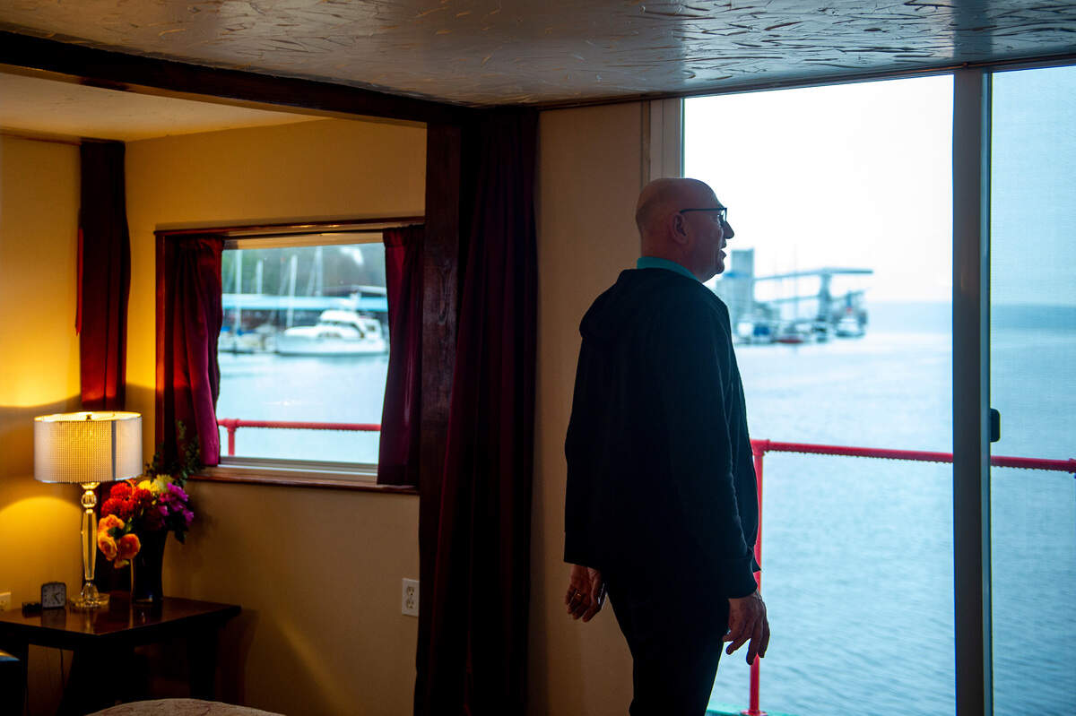 Dennis Redmon looks out the sliding doors in the master bedroom on the second deck of the Annabelle.