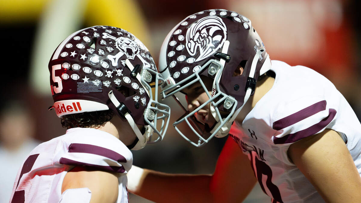 Enumclaw’s Colton Paulson (5) and Gavin Trachte (10) celebrate connecting for a touchdown during the second half of the game at Pete’s Pool Ballfield, on Friday, Sept. 27, 2024, in Enumclaw, Wash.
